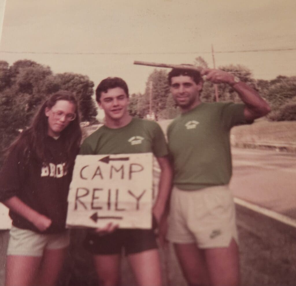 Camp Reily counselors gathered to guide visitors toward camp with a sign
